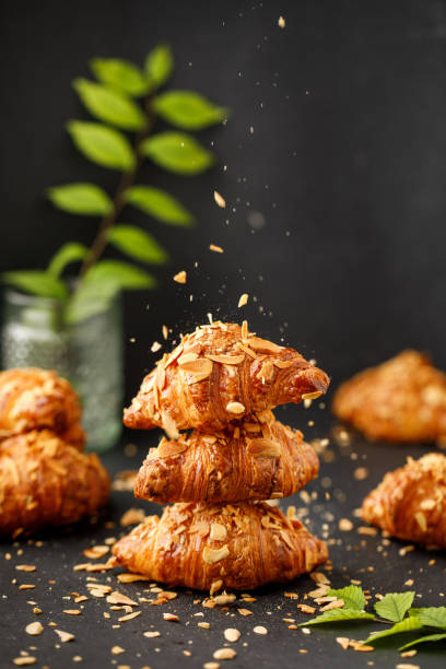 istock Croissant with tea and honey by hand. 1412382108