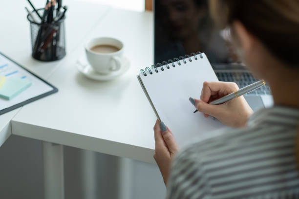 istock Business asian hand holding pencil and writing note on wood table,Checklist Notice Remember Planning Concept 1412382159