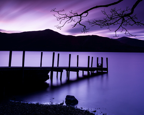 A bright purple sunrise sky over Esthwaite Water Lake in England