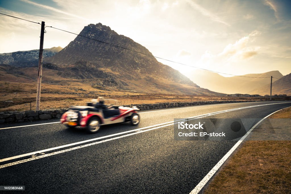 Open top classic sports car driving through Snowdonia, Wales, United Kingdom, Europe Vintage Car Stock Photo