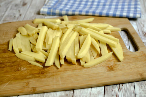 istock sliced potatoes ready to be fried on a wooden board 1412385126