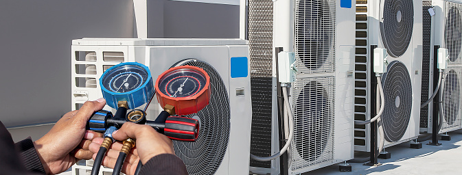 Air conditioner technician services outdoor AC unit and the Gas Generator