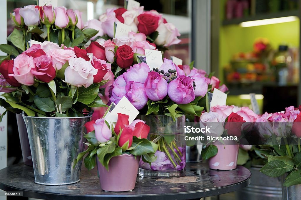 Buckets of fresh pink and red roses outside a florist shop Bunches of fresh vivid colored flowers for sale outside a flower shop in the romantic city of Paris. Flower Shop Stock Photo