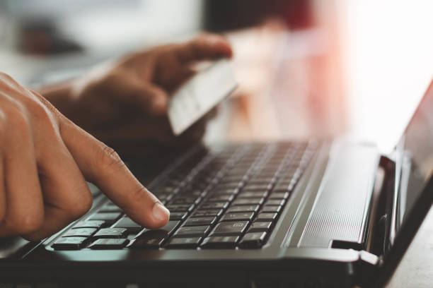 istock Businessman using laptop computer with a credit card making an online order. Business, online shopping, e-commerce, internet banking, spending money, online payment, working from home concept. 1412388028