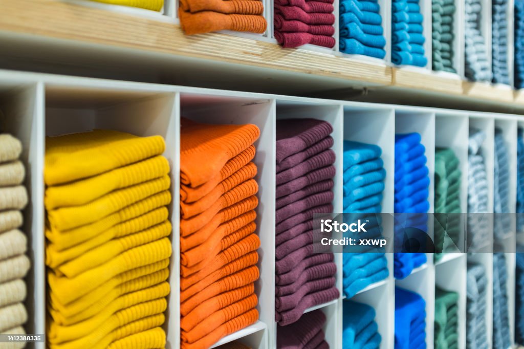 Multi colored socks stacked on shelves in the store Unisex Stock Photo