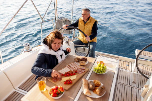 istock Joyful Married Couple Having A Dinner On The Sailing Boat 1412388524