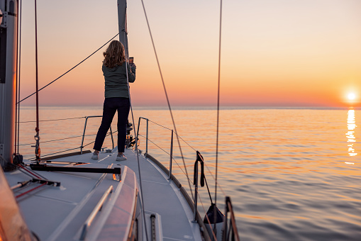 Sailing boat on Wadden Sea at sunrise, Sylt island, North Frisia, Schleswig-Holstein, Germany