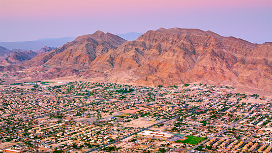 Aerial view of neighbourhood in Las Vegas beneath Frenchman Mountain, Nevada, USA.