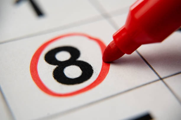 The calendar 8th day of the month is circled. A red marker circles the eighth day of the month from the paper calendar. A very important date in the calendar. stock photo