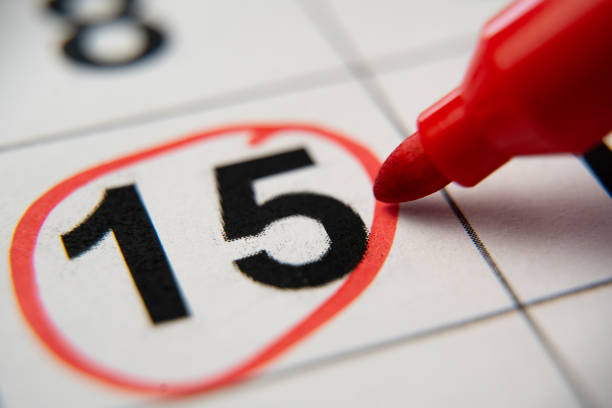 The calendar 15th day of the month is circled. A red marker circles the fifteenth day of the month from the paper calendar. A very important date in the calendar. stock photo