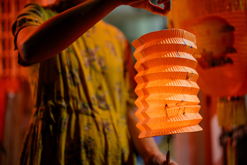 Image of an Asian Chinese woman holding lantern during mid autumn festival celebration