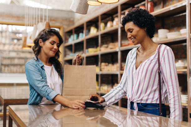 istock Female customer making an NFC payment in a ceramic store 1412394522