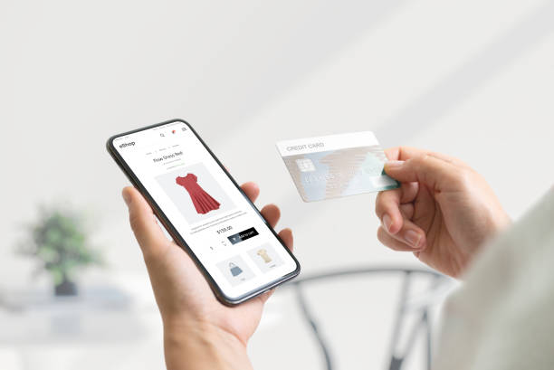istock Shopping online with smart phone and credit card concept. Modern e-commerce web page with with women's clothing 1412396128