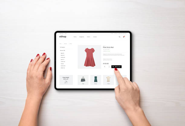 istock Online shopping with a tablet. Red women's dress on the e-commerce web page 1412396133