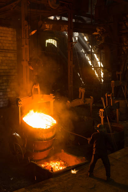 istock Metallurgist removing slack from hot molten metal 1412397607