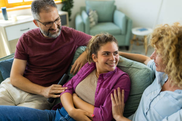 istock Caucasian family having fun time while watching TV 1412398386