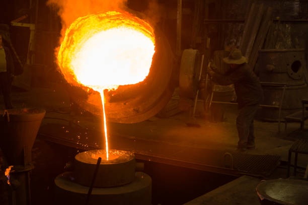 istock Hot molten metal pouring into a mould 1412398394