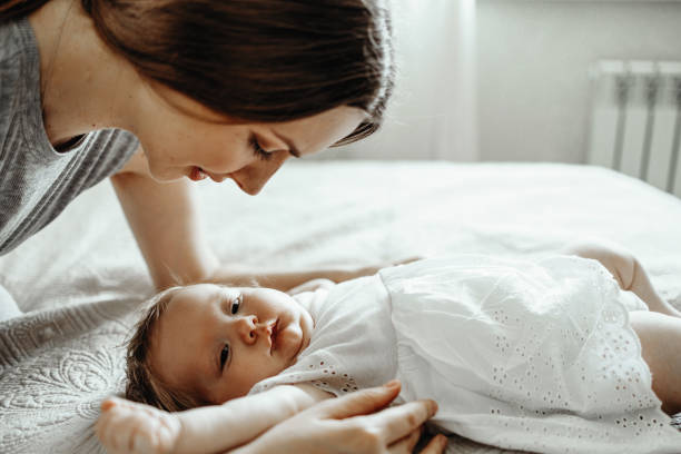 istock Baby sleeps with mather 1412403127