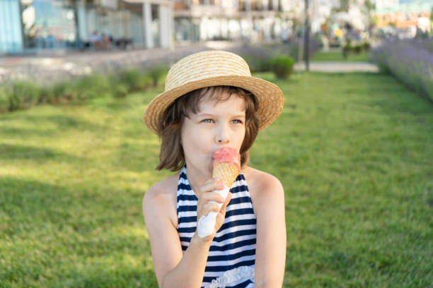 istock Cute girl eats ice cream 1412403153