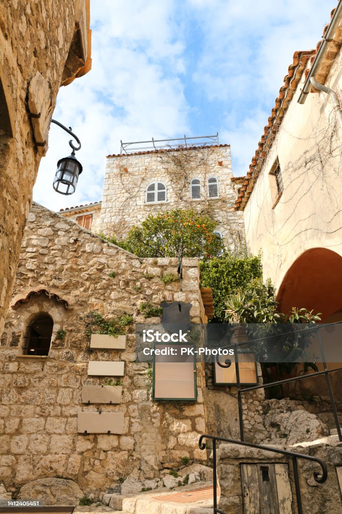Narrow street in medieval Eze Village on Cote d'Azur, French Riviera, France View of the narrow streets and stone houses of eze village in the french riviera Beauty Stock Photo