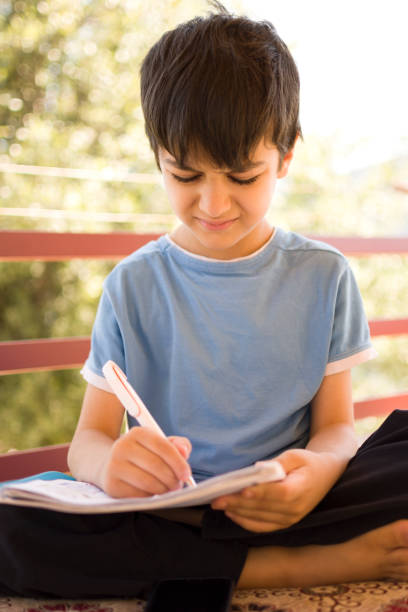 Handsome little boy studying lesson to eye health problems in children