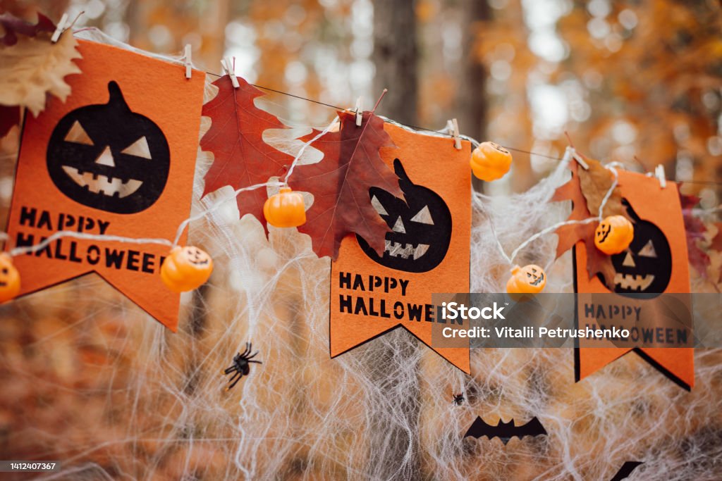 Happy Halloween concept Banners, garland, some leaves on the net outdoor in the park Decoration Stock Photo