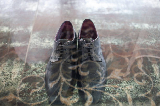 istock Black wedding shoes stand on a vintage floor 1412408183