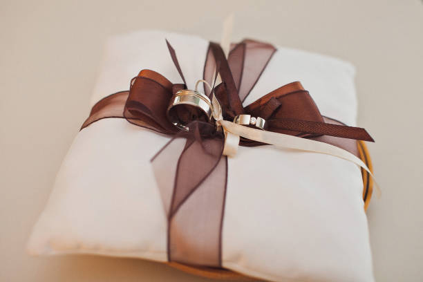 istock Two wedding rings on a lace pillow 1412408726