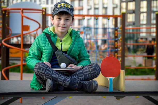istock Happy ping pong player think about a game. young boy sitting aft 1412409886