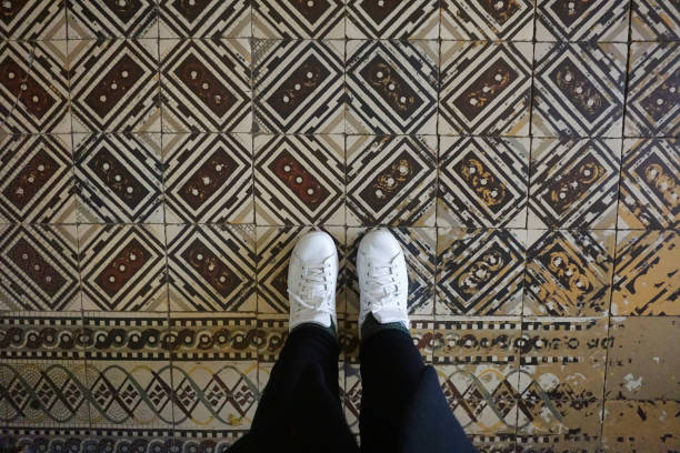 istock historical square and patterned ground stones and a pair of feet stepping on them 1412410820