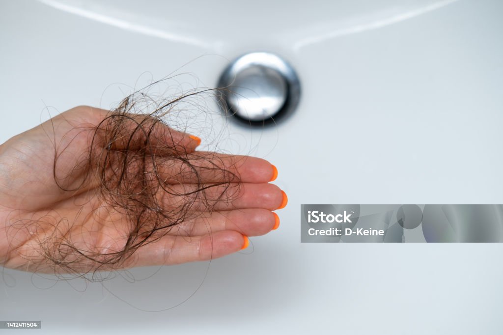 Hair loss problem Female hairs in sink. Hair loss concept. Falling Stock Photo