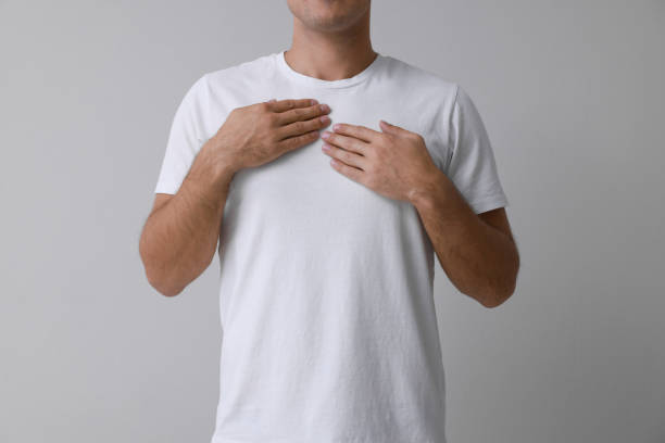 istock Man holding hands near chest on grey background, closeup 1412413096