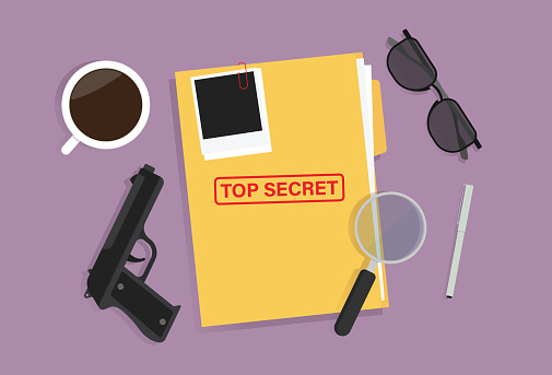 Top secret folder, pen, glasses, gun, cup and a magnifying glass on the table