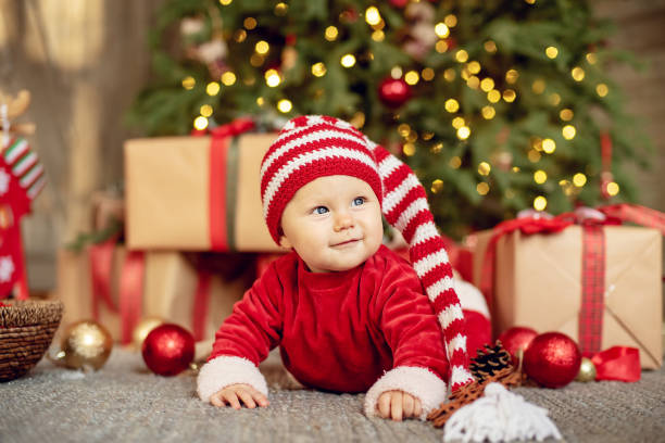 istock The little girl under the Christmas tree 1412415036