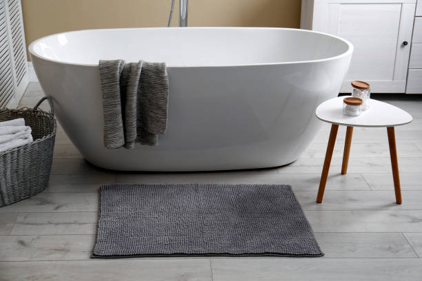 istock Soft grey mat on floor near tub in bathroom. Interior design 1412415142