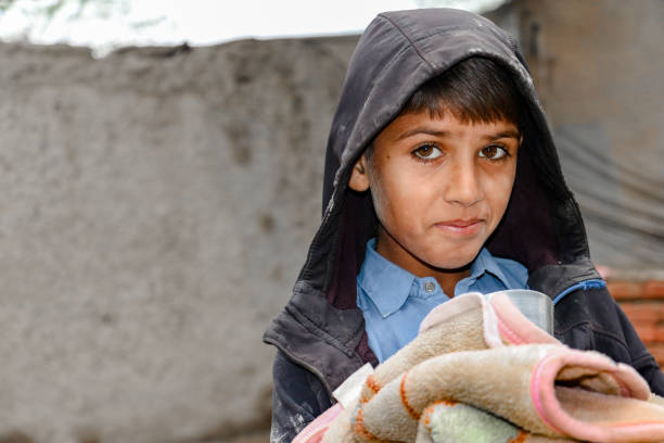 istock asian homeless boy with sad face smile 1412415546