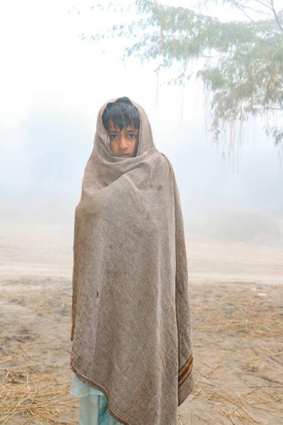 istock young boy wearing winter shawl in cold season 1412416615