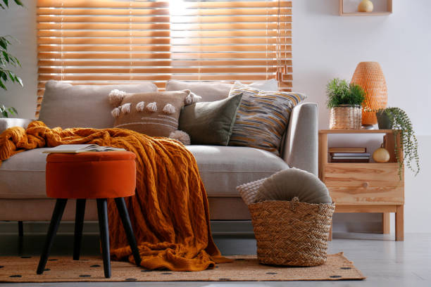 istock Stylish living room interior with comfortable sofa and ottoman 1412416999