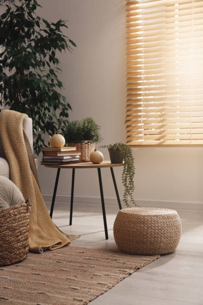 istock Stylish living room interior with table and wicker pouf 1412417022