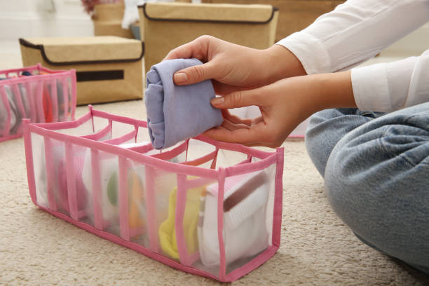 istock Woman folding clothes on floor, closeup. Japanese storage system 1412417305