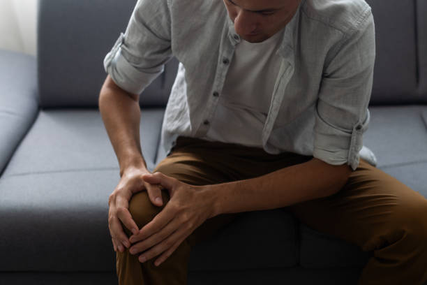 istock Man hurt his knee hold by hand. 1412417380