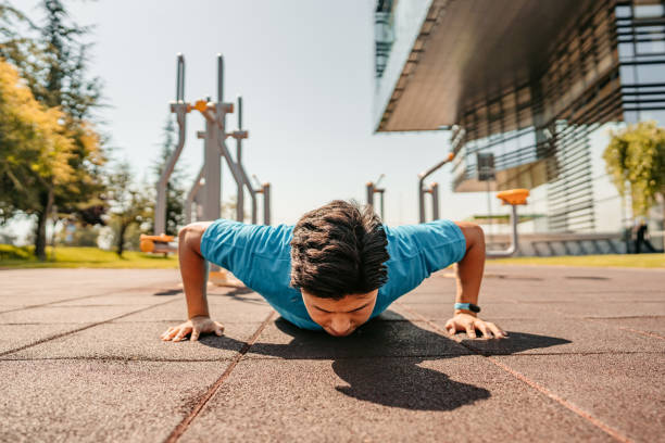 istock Young Man Doing Push-Ups Outdoors 1412418932