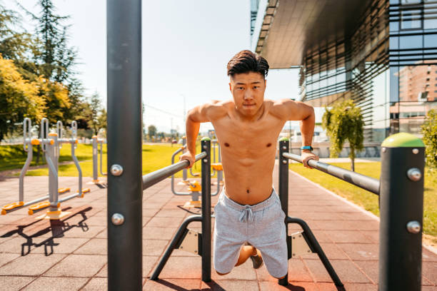 istock Young Man Doing Dips On A Bar Outdoors 1412419368