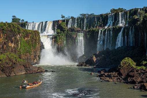 Tourist boat exploring Iguazu Falls on the border of Argentina and Brazil.
