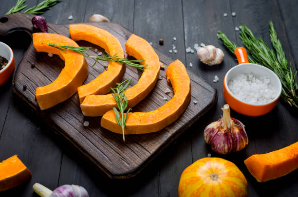 istock Pumpkin pieces on the cutting board on wooden table 1412421161