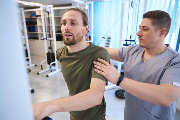 istock Physiotherapist is engaged with the patient on the simulator 1412422023