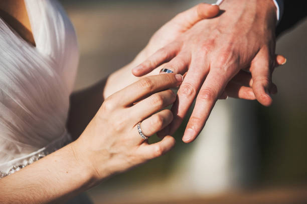 istock Bride and groom exchange rings at the wedding ceremony 1412422862