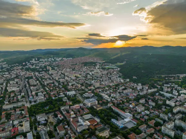 Wide dron shot of Stara Zagora, city in Bulgaria at sunset (Bulgarian: Общ план на град Стара Загора по залез). The photo is taken with DJI quadcopter Mavic III