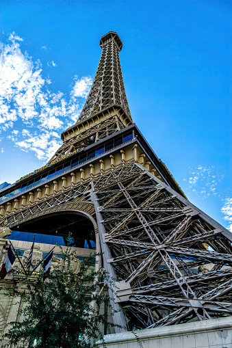 Eiffel Tower behind trees in Paris, France.