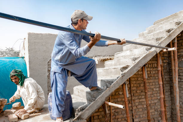 istock worker picking steel to building top 1412424394